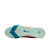 Bottom view of a Nike athletic shoe's mint green textured sole, featuring a blue chevron pattern and a teal swoosh logo.