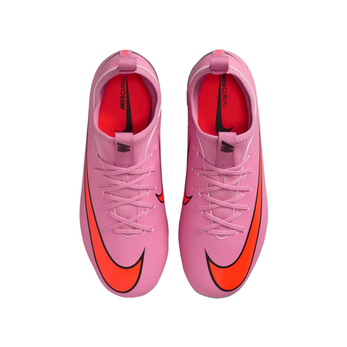 Top-down view of a pair of bright pink Nike Mercurial soccer cleats with large orange swoosh logos and pink laces, set against a solid black background.