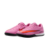 Pair of pink Nike Air Zoom indoor soccer cleats with a large orange swoosh on a solid black background.