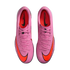 Top-down view of pink Nike Mercurial soccer shoes with orange swooshes on a black background.