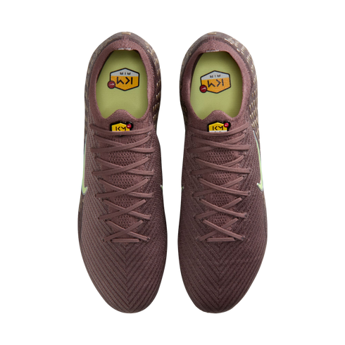 Top-down view of a pair of purple soccer cleats with yellow KM AIR logos on the tongues and insoles.