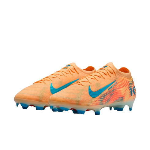 A pair of orange Nike soccer cleats with blue accents and studs against a black background.