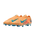 A pair of orange Nike soccer cleats with blue accents and studs against a black background.