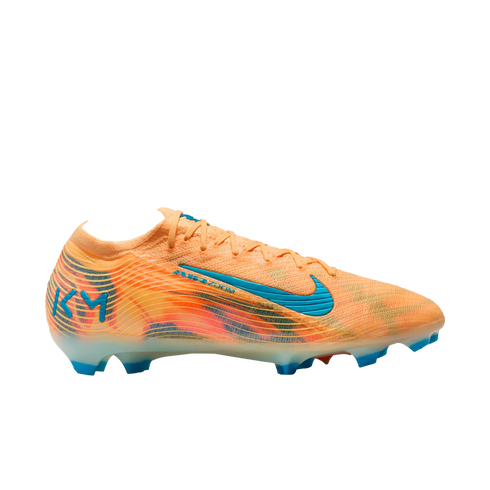 Side profile of an orange Nike soccer cleat with blue details and 'KM' logo on the heel, set against a black background.