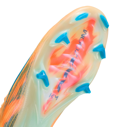 Close-up of a translucent soccer cleat soleplate with orange and green patterns, bright blue bladed studs, and "AIR ZOOM" text.