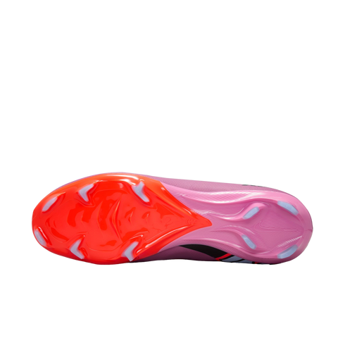 Bottom view of a pink and orange Nike soccer cleat, showing the textured soleplate and light blue studs.