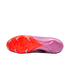Bottom view of a pink and orange Nike soccer cleat, showing the textured soleplate and light blue studs.
