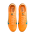 A top-down view of a pair of bright orange Nike soccer cleats with light blue accents and laces, isolated against a solid black background.