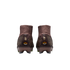 Rear view of two brown and gold Nike soccer cleats with high-top collars and "Zm AIR" logos on the heels, set against a black background.
