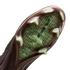 Close-up of a Nike soccer cleat's soleplate with a brown frame, light green triangular studs, and a translucent green center showing "AIR ZOOM" branding and a dotted pattern.