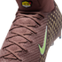 Close-up of a maroon knit Nike soccer cleat featuring a lime green swoosh, gold circular patterns, and a yellow "KM AIR" logo on the high-top ankle collar.