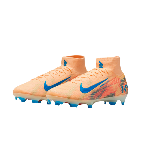 A pair of peach-colored Nike soccer cleats with bright blue accents and high-top collars, set against a solid black background.