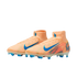 A pair of peach-colored Nike soccer cleats with bright blue accents and high-top collars, set against a solid black background.