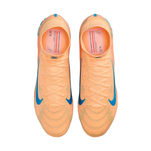 Top-down view of a pair of bright orange Nike soccer cleats with blue swooshes, displayed against a solid black background.