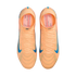 Top-down view of a pair of bright orange Nike soccer cleats with blue swooshes, displayed against a solid black background.