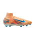 A peach Nike soccer cleat with a colorful graphic pattern, a blue swoosh, and blue "KM" branding on the heel, set against a solid black background.
