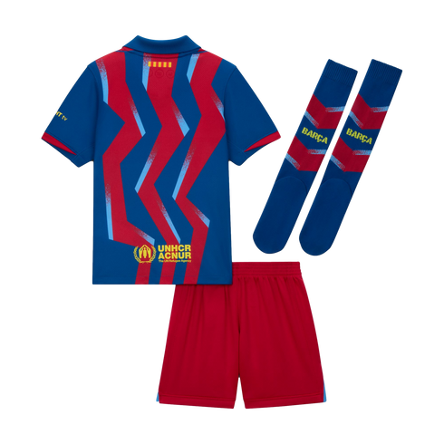 Back view of an FC Barcelona soccer kit featuring a blue jersey with red zig-zag patterns, solid red shorts, and matching blue and red socks.