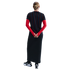 Back view of a person with a bun wearing a black pinstriped top over long red sleeves, a long black skirt, and black and white Nike sneakers.