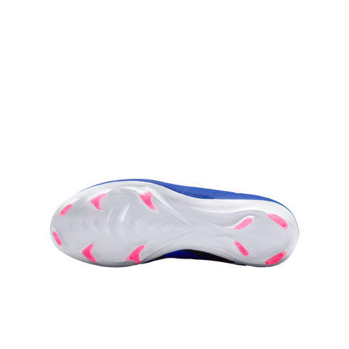 The bottom view of a blue Nike soccer cleat with a white sole and bright pink studs, shown against a solid black background.