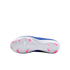 The bottom view of a blue Nike soccer cleat with a white sole and bright pink studs, shown against a solid black background.