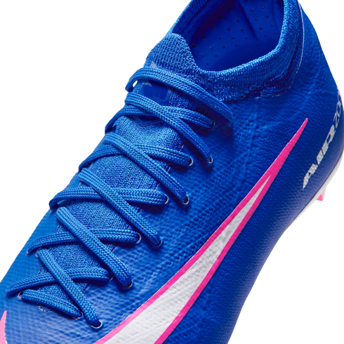 Close-up of a textured blue Nike soccer cleat with matching laces and a white swoosh outlined in pink, against a black background.