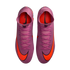 Top-down view of pink Nike Mercurial soccer cleats with bright orange swooshes and high-top collars against a black background.