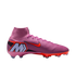 A pink Nike high-top soccer cleat with orange accents and a large "M" logo on the heel, shown in profile against a solid black background.