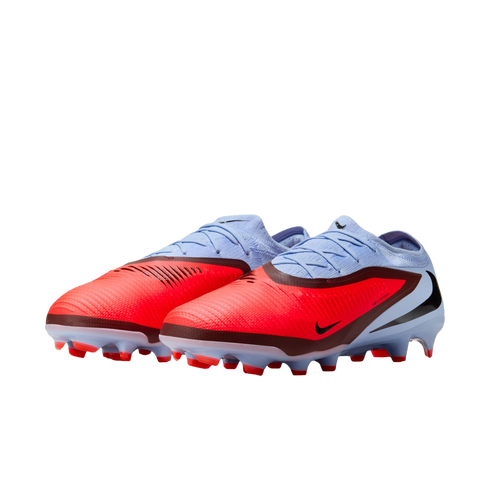Vibrant red and light blue Nike soccer cleats with black accents, shown from a side-angle view against a solid black background.