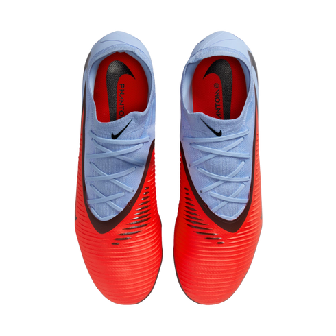 Top-down view of Nike Phantom soccer cleats featuring a vibrant red forefoot and light blue collar and laces on a black background.
