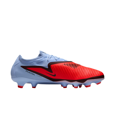 A light blue and bright red Nike Phantom Venom football boot featuring a textured strike zone, black swoosh, and light blue studs with red tips.