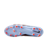 Underside view of a light blue Nike soccer cleat with bright orange studs and a black Nike swoosh, set against a black background.