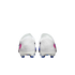 Rear view of white soccer cleats with pink and blue accents against a black background.