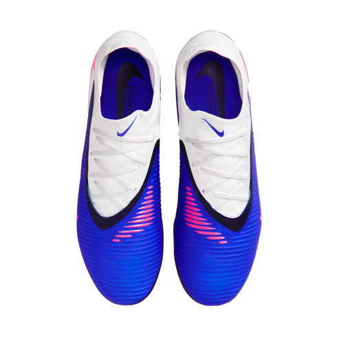 Top-down view of blue and white Nike Phantom soccer cleats with pink accents and white laces. The textured blue forefoot and purple interior are clearly visible.