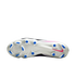 The white soleplate of a Nike soccer cleat with blue studs and a pink Nike swoosh logo, set against a black background.