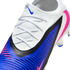 A close-up of a white and blue Nike soccer cleat with pink accents, featuring white laces and a ribbed blue texture.
