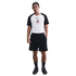 A man wearing a Nike Sport Club Corinthians Paulista t-shirt, black athletic shorts, black crew socks, and black sneakers, standing against a white background.