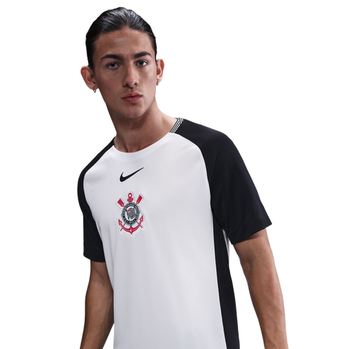A male model wearing a white and black Nike soccer jersey featuring the Sport Club Corinthians Paulista crest, set against a plain white background.