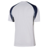 Back view of a white short-sleeved sports jersey featuring dark blue and grey paneling on the shoulders and upper sleeves.