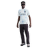A man wearing a white and blue patterned Inter Milan soccer jersey, dark pants, and sunglasses, standing against a white background.