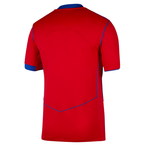 Back view of a bright red short-sleeved sports jersey featuring blue trim on the collar, sleeve cuffs, and side seams against a solid black background.