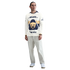 Man wearing a long-sleeved cream Pumas UNAM soccer jersey, light gray trousers, and white sneakers, standing against a plain white background.
