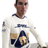 A man in a cream-colored long-sleeve Pumas UNAM soccer jersey with navy and gold accents, featuring DHL and Nike logos, against a white background.