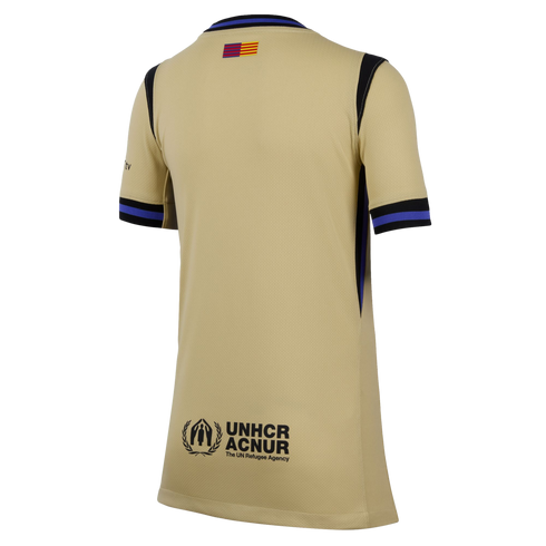 Back view of a gold soccer jersey with black and blue trim, a small red and yellow flag at the neck, and the UNHCR ACNUR logo at the bottom.