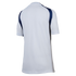 Rear view of a white short-sleeved athletic jersey featuring navy blue shoulder panels and gray side detailing.