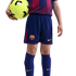 A child wearing an FC Barcelona soccer uniform holds a neon yellow soccer ball against a black background.