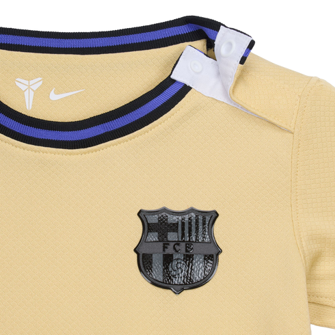 Gold FC Barcelona baby jersey featuring a black crest, white Nike and Kobe Bryant logos, striped collar, and shoulder snaps.