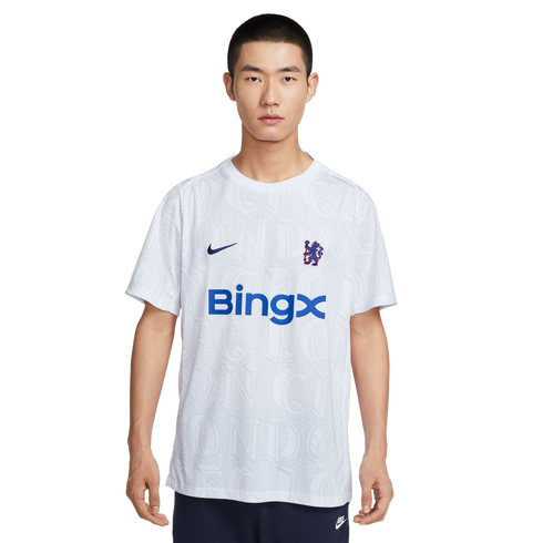 A man models a white Nike Chelsea FC t-shirt with a blue BingX logo and faint graphic pattern, set against a plain white background.