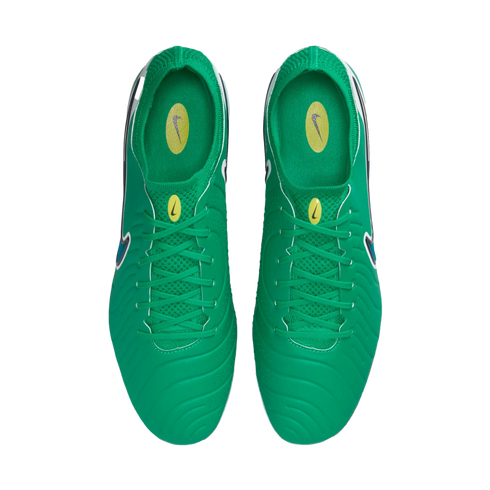 Top-down view of bright green Nike soccer cleats featuring textured uppers, matching green laces, and yellow logo accents on the tongues and insoles, shown on a white background.