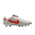 White Nike soccer cleat with a red swoosh against a black background. Features include a perforated leather upper and clear studs.