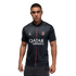Man modeling a black PSG jersey with a thin vertical pink stripe and Qatar Airways logo against a black background.